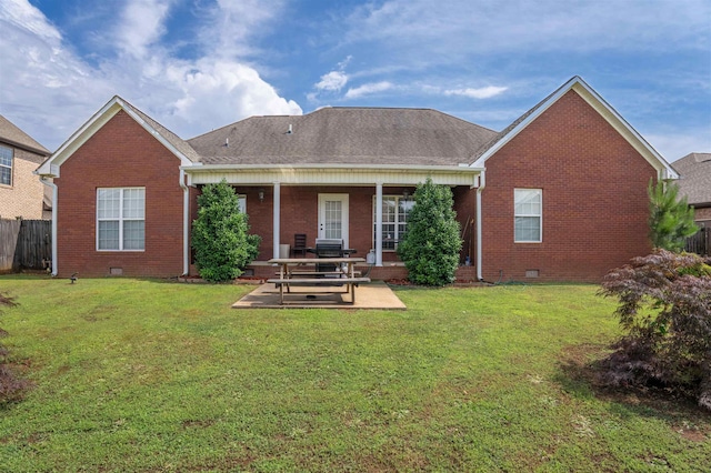  - rear view of property featuring brick siding, a patio area, crawl space, and a shingled roof