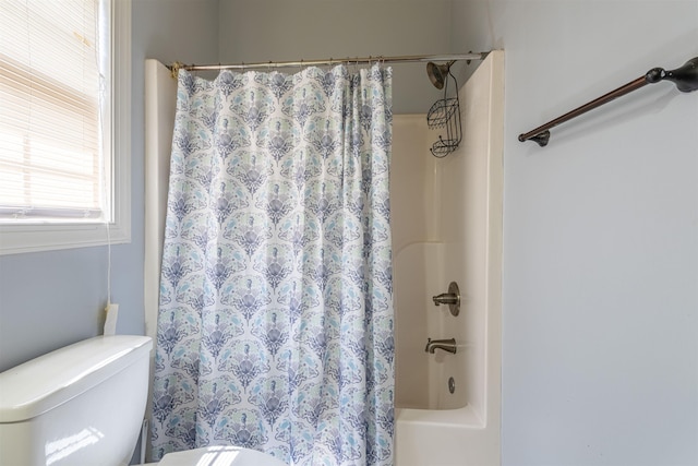  - full bathroom featuring toilet and shower / bath combo with shower curtain