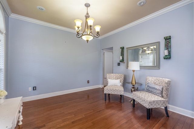  - living area featuring a chandelier, wood finished floors, and crown molding