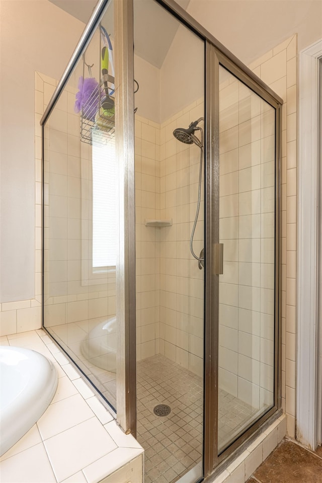  - bathroom with a shower stall and a bath