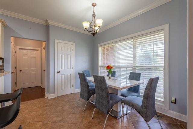  - dining area featuring ornamental molding, a chandelier, and light tile patterned floors