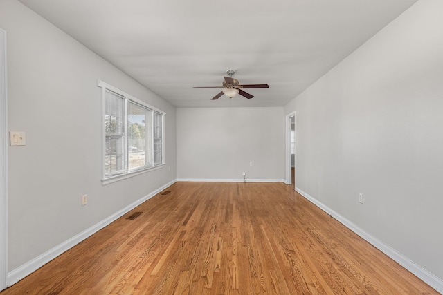  - spare room with ceiling fan, light wood finished floors, and baseboards