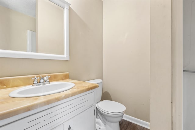 - bathroom featuring vanity and wood finished floors
