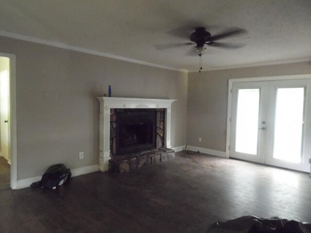  - unfurnished living room featuring a ceiling fan, crown molding, wood finished floors, french doors, and a fireplace
