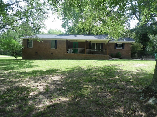  - rear view of property featuring crawl space, a lawn, brick siding, and a porch