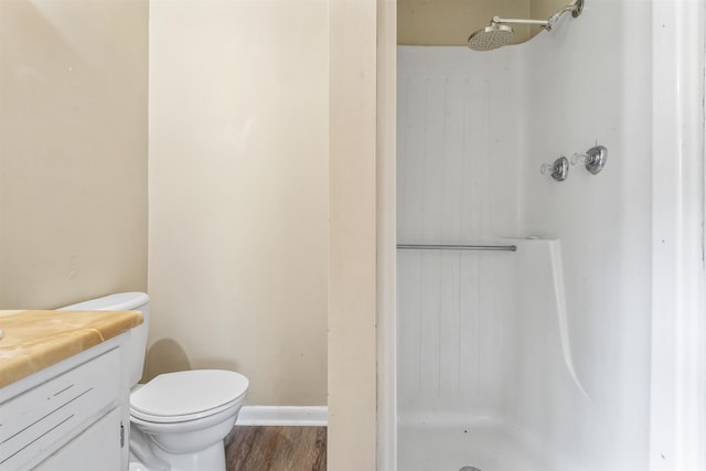  - bathroom featuring a shower stall, wood finished floors, and vanity