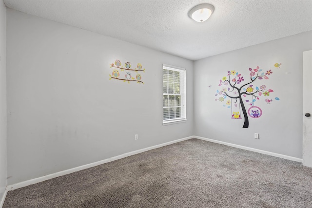  - unfurnished room featuring a textured ceiling and carpet floors