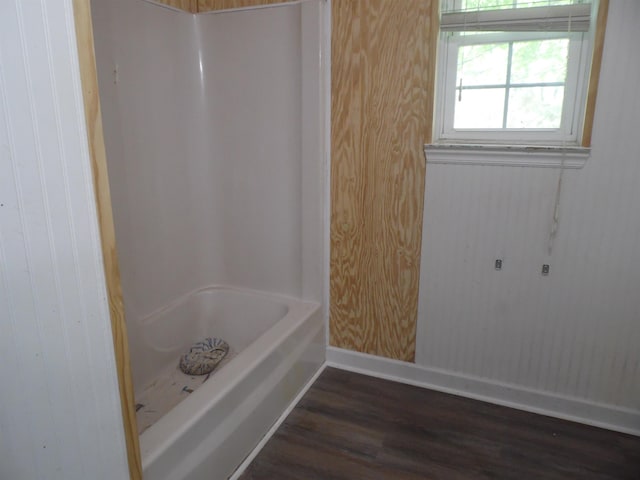  - full bath featuring wood finished floors and tub / shower combination