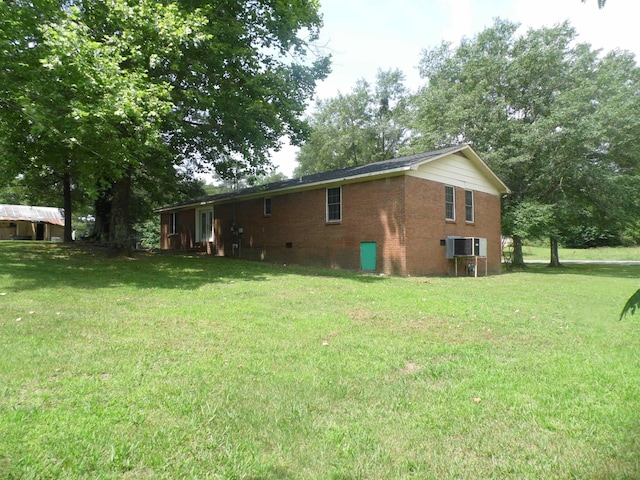  - view of home's exterior with a lawn and brick siding