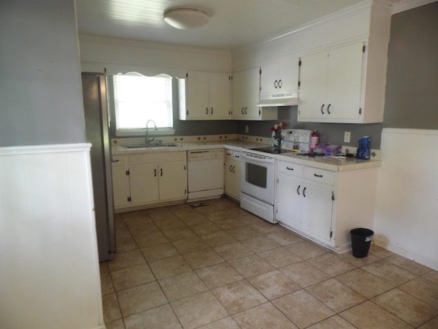  - kitchen featuring white appliances, under cabinet range hood, light countertops, ornamental molding, and wainscoting