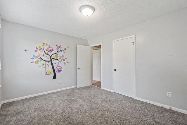  - unfurnished bedroom with carpet flooring and a textured ceiling