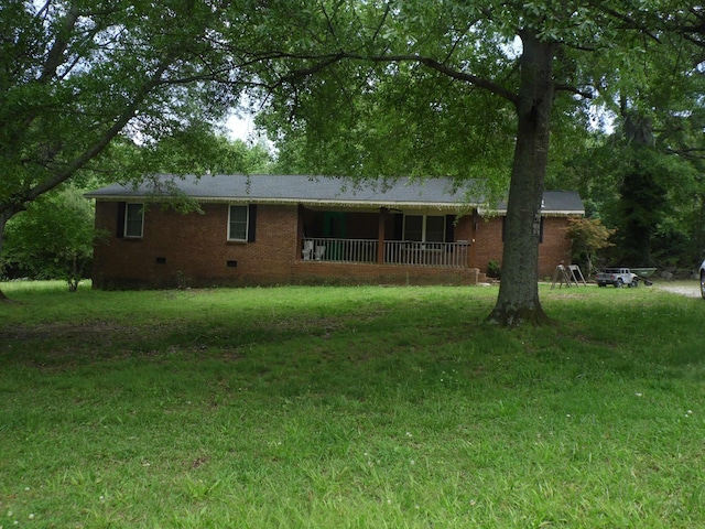  - back of house with crawl space, brick siding, and a yard