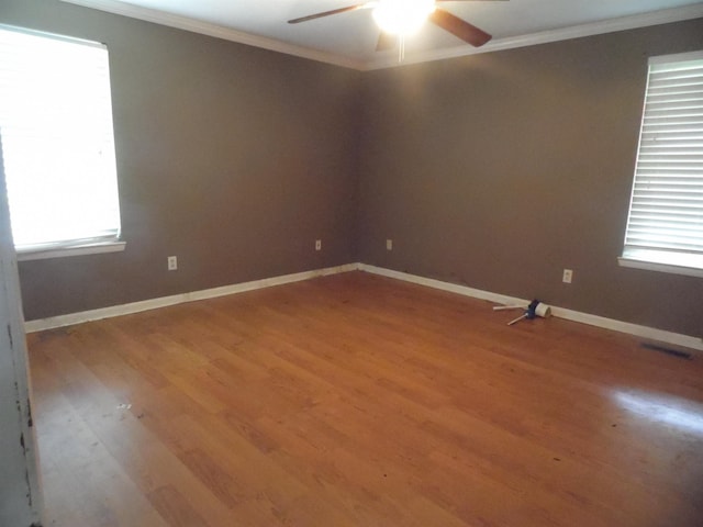 - empty room with ornamental molding, a ceiling fan, and light wood-style floors