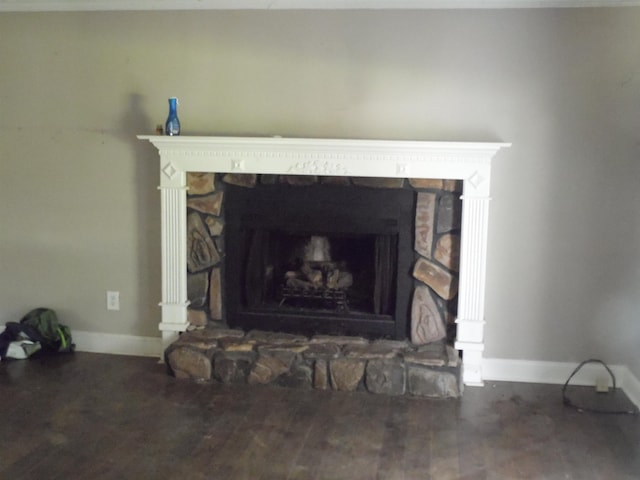  - detailed view of a stone fireplace and wood finished floors