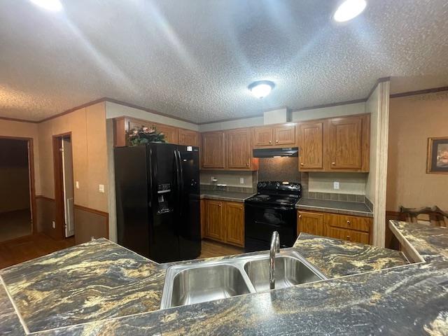 kitchen with crown molding, sink, a textured ceiling, and black appliances