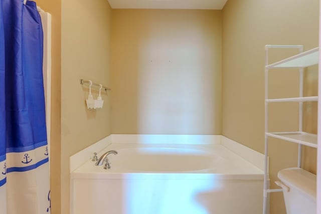 bathroom with toilet and a bathing tub