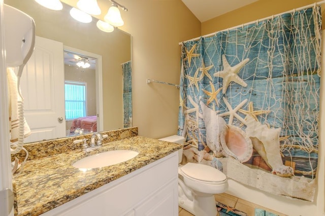 full bathroom featuring vanity, ceiling fan, shower / bathtub combination with curtain, tile patterned flooring, and toilet