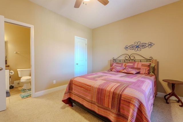 carpeted bedroom with connected bathroom and ceiling fan
