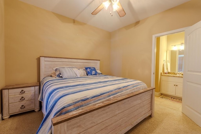 carpeted bedroom featuring connected bathroom and ceiling fan