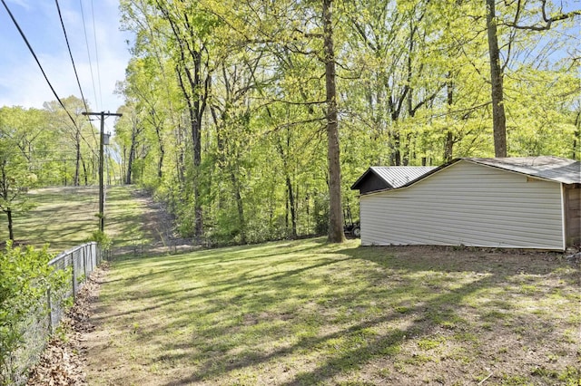 view of yard with fence and a forest view