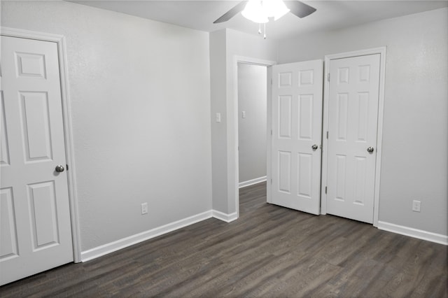 unfurnished bedroom featuring baseboards, a ceiling fan, and dark wood-style floors