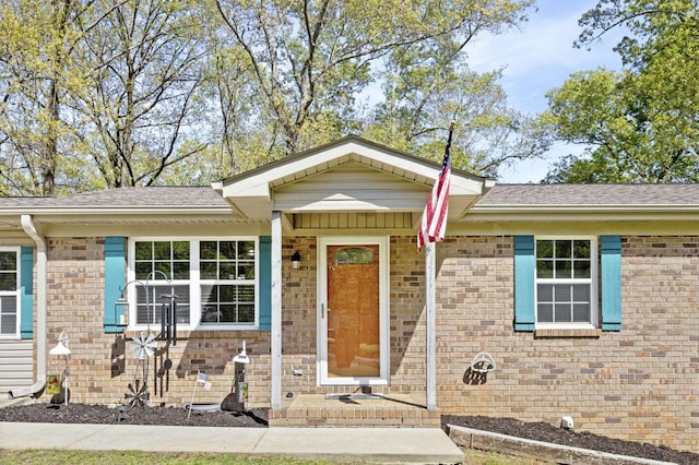 ranch-style house with brick siding and roof with shingles