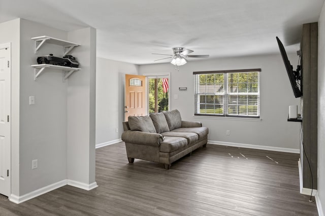 sitting room with baseboards, a ceiling fan, and dark wood-style floors