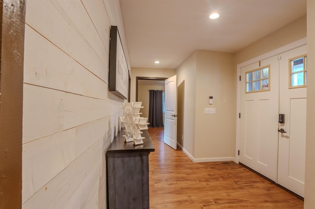 entryway with light wood-style floors, baseboards, and recessed lighting