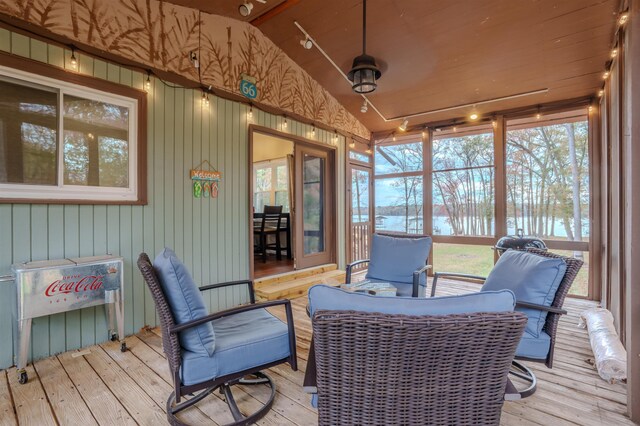 sunroom with lofted ceiling and rail lighting