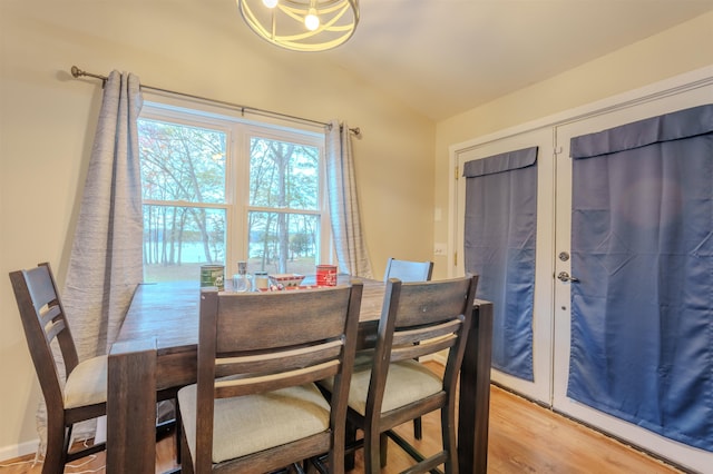 dining area featuring lofted ceiling and light wood finished floors