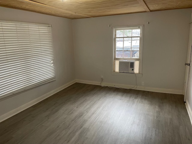 empty room featuring dark hardwood / wood-style flooring, cooling unit, and wooden ceiling