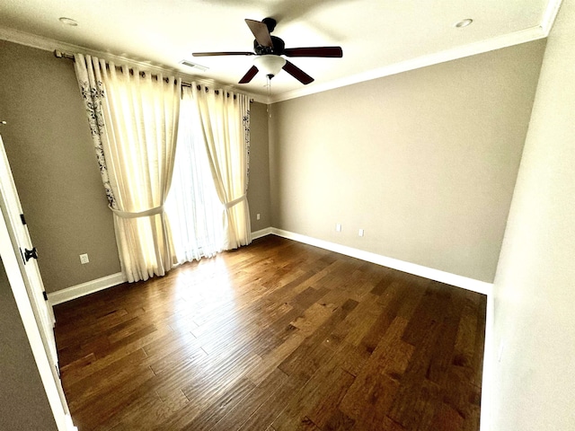 empty room with ceiling fan, dark hardwood / wood-style flooring, and ornamental molding