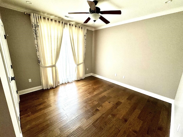 unfurnished room with dark hardwood / wood-style floors, a wealth of natural light, ornamental molding, and ceiling fan