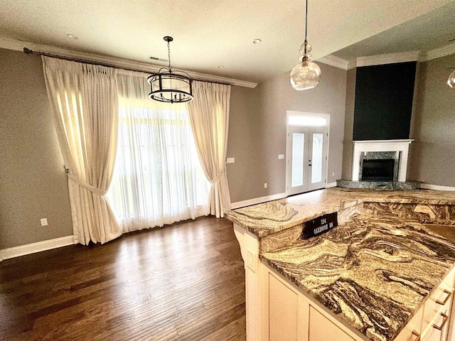 kitchen with pendant lighting, stone countertops, and dark wood-type flooring