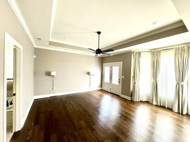 unfurnished room featuring wood-type flooring, a raised ceiling, ceiling fan, and crown molding