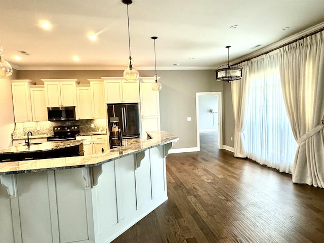 kitchen featuring black appliances, white cabinets, sink, hanging light fixtures, and light stone countertops