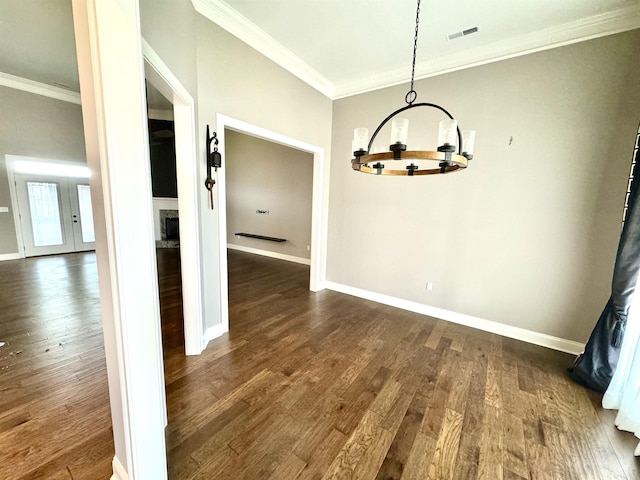 unfurnished dining area with a chandelier, dark hardwood / wood-style flooring, and ornamental molding