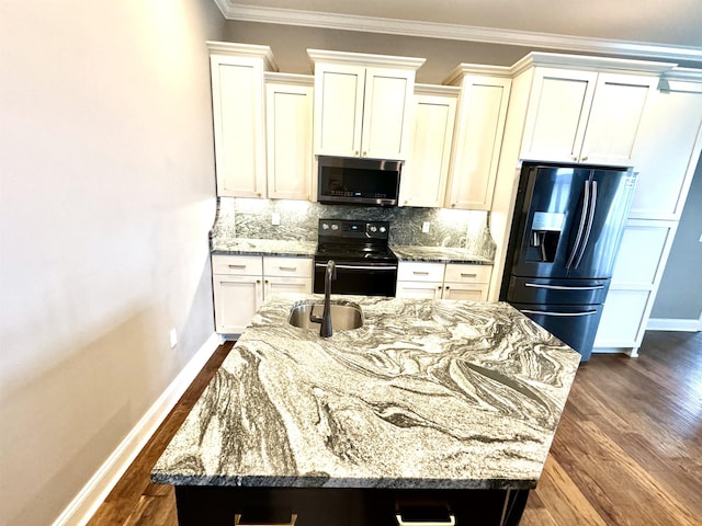 kitchen featuring black electric range, light stone counters, a kitchen island with sink, and refrigerator with ice dispenser