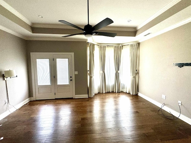 foyer entrance with a raised ceiling, a wealth of natural light, and ceiling fan