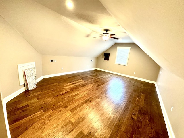 additional living space with a textured ceiling, ceiling fan, lofted ceiling, and hardwood / wood-style flooring