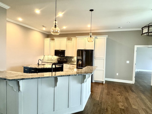 kitchen featuring black appliances, pendant lighting, white cabinets, and backsplash