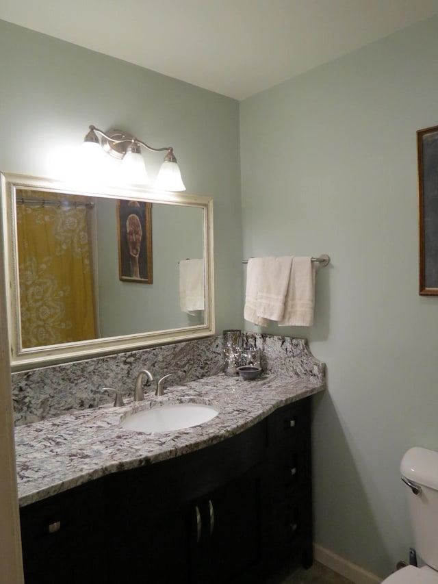 bathroom featuring vanity and toilet