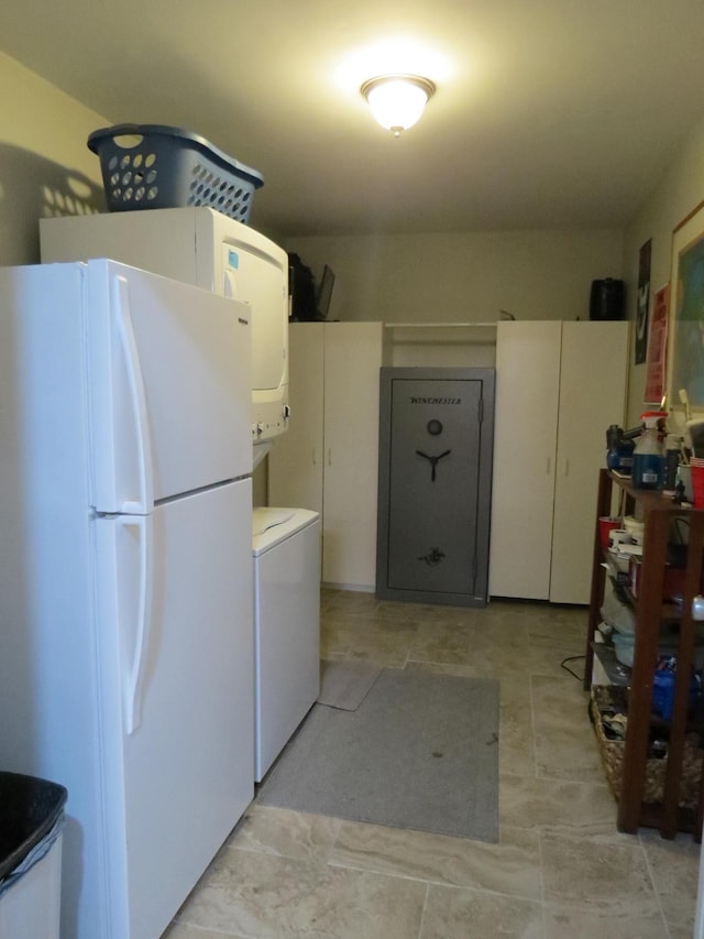 laundry room featuring stacked washer / drying machine