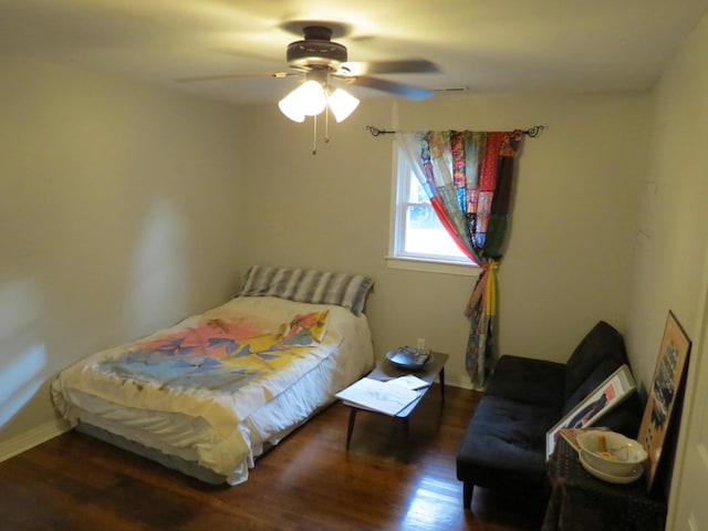 bedroom with ceiling fan and dark wood-type flooring