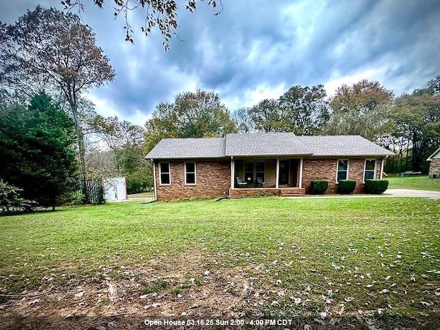 ranch-style house with brick siding and a front yard