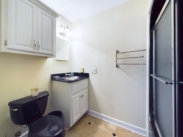 bathroom with tile patterned flooring, vanity, and toilet