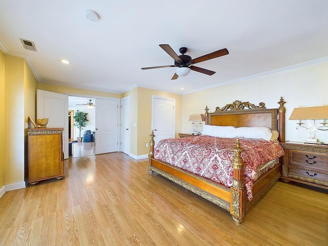 bedroom featuring light hardwood / wood-style flooring, ceiling fan, and ornamental molding