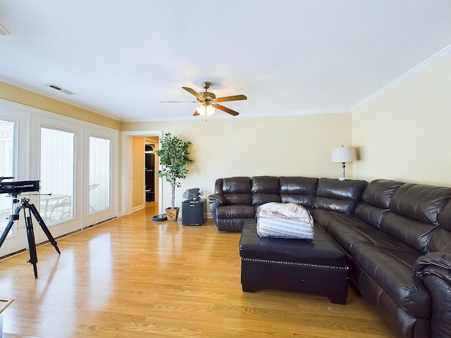 living room with ceiling fan, light hardwood / wood-style floors, and ornamental molding