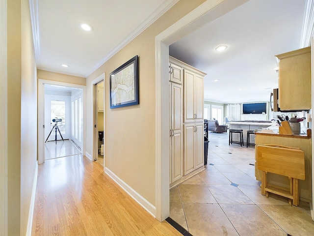 hallway featuring light hardwood / wood-style flooring and crown molding