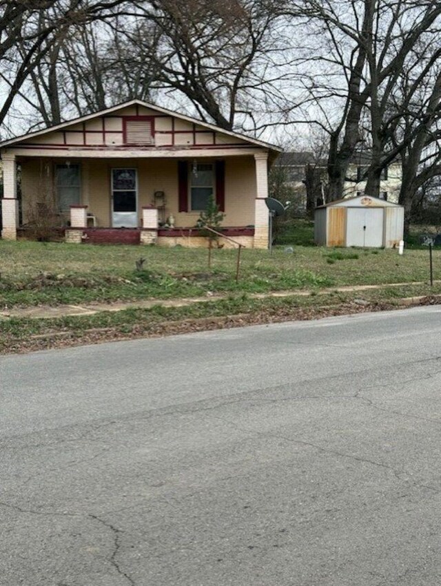 bungalow-style house with a storage shed